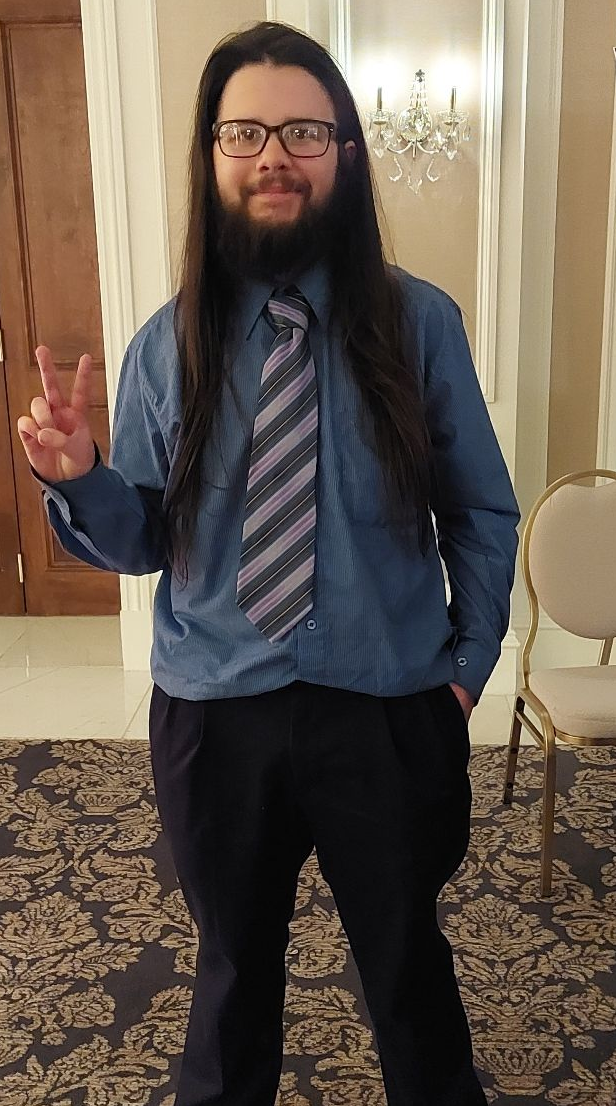 Image of a bearded man in fancy dress.